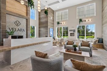 High ceiling lobby with reception desk and lounge seating